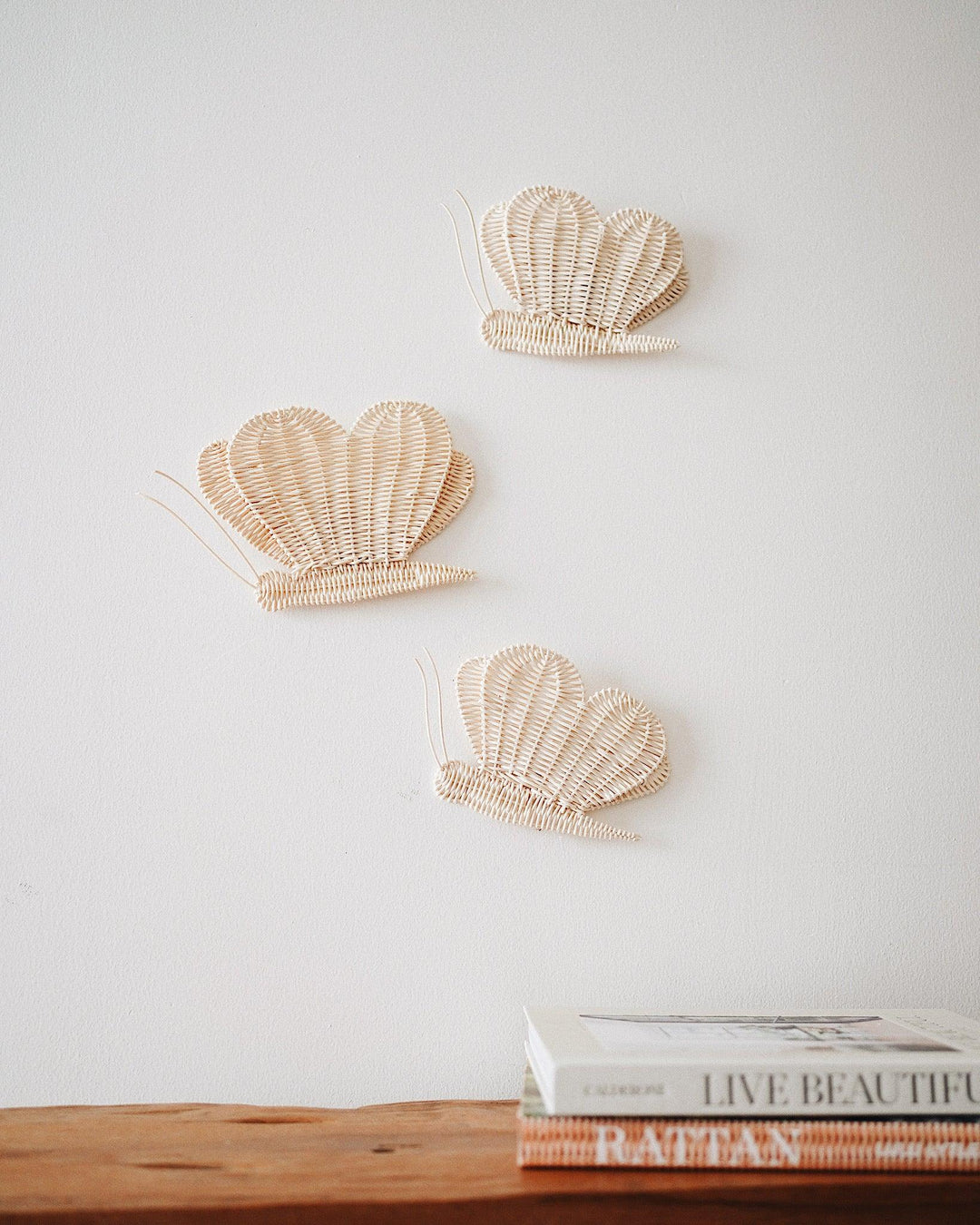 Ethically made butterfly-shaped rattan wall art, perfect for adding natural charm to home décor.